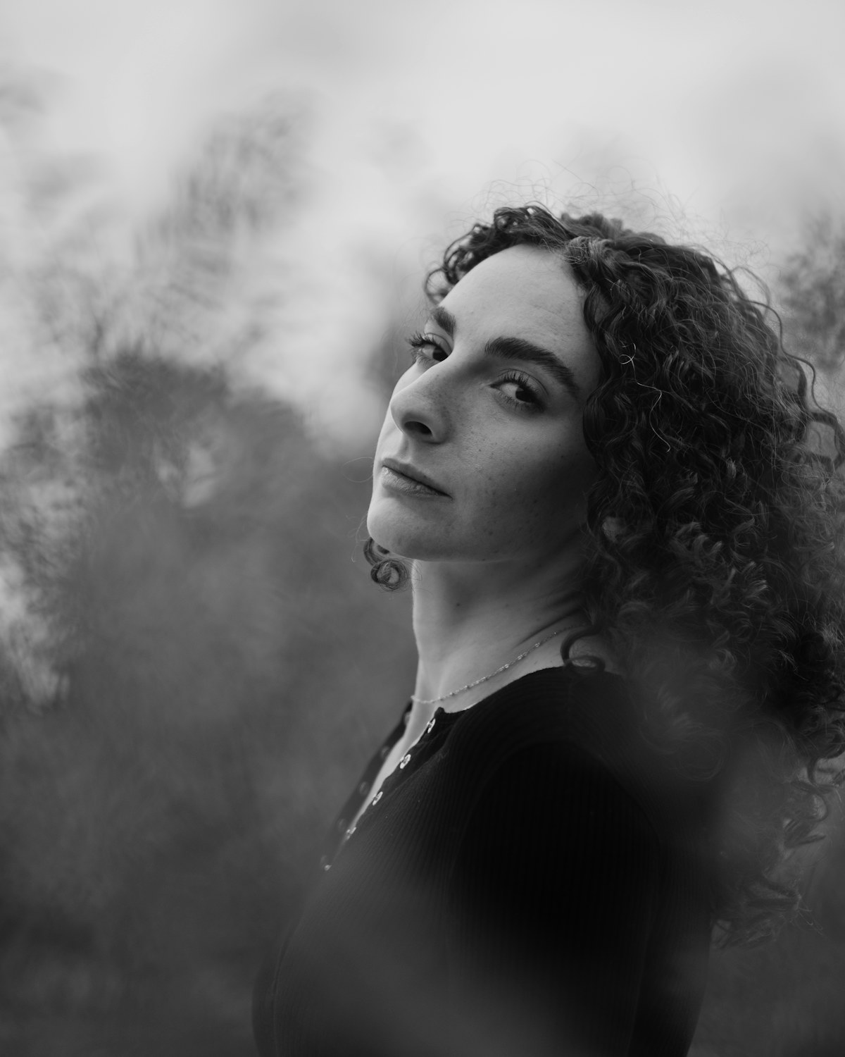 Portrait with long natural curls, black and white