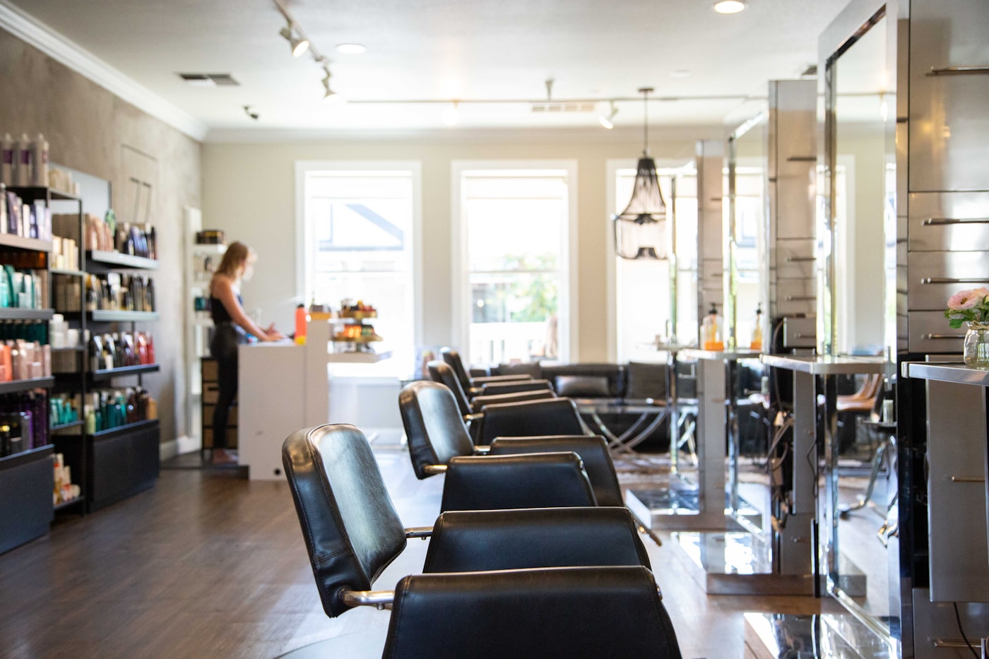 Salon floor — leather styling chairs and mirrors in natural light