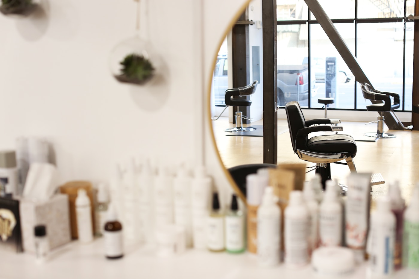 Styling station mirror with hair products in the foreground